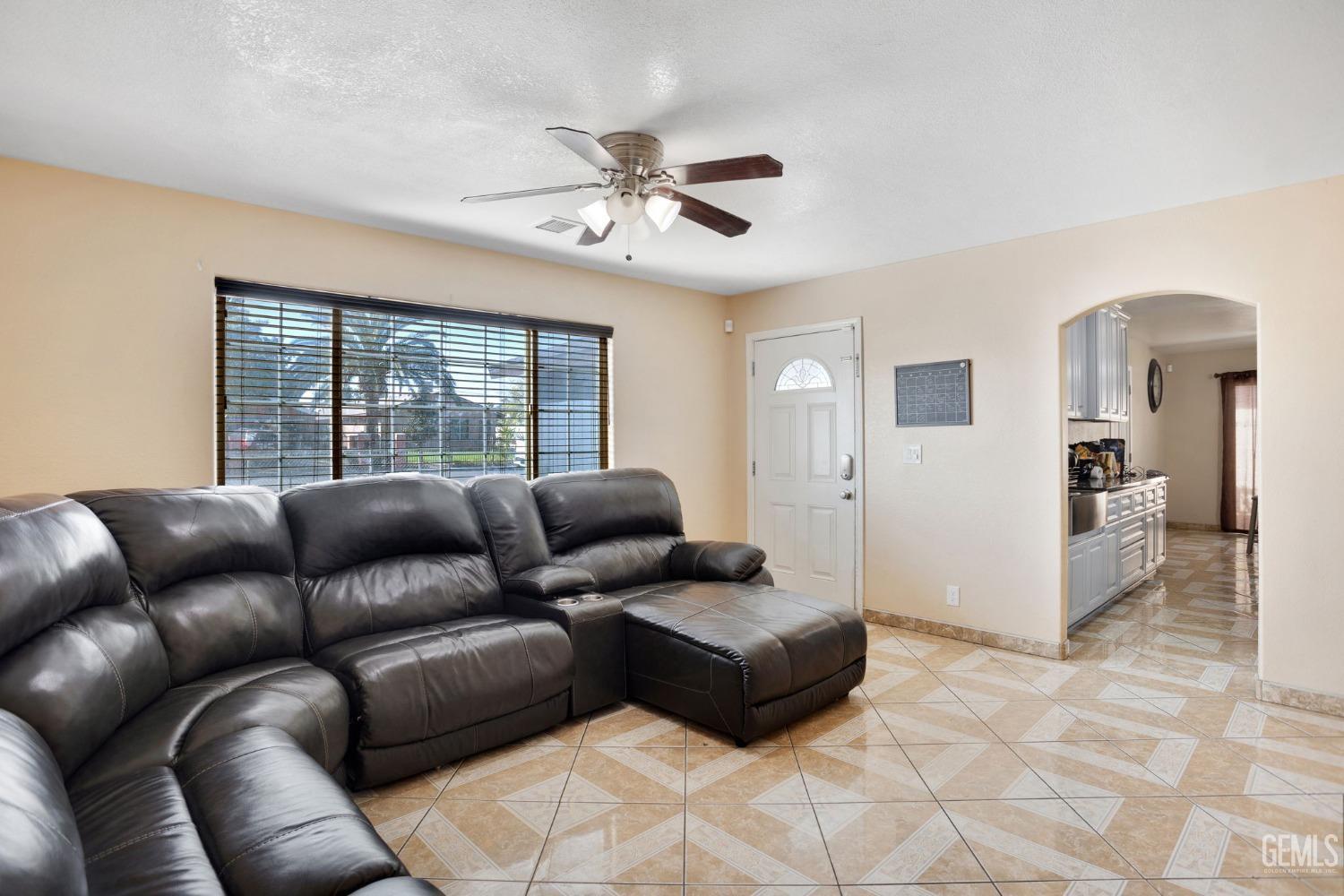 Undisclosed Address Bakersfield, CA 93307 - Photo 13 of 42 a living room with furniture and a large window