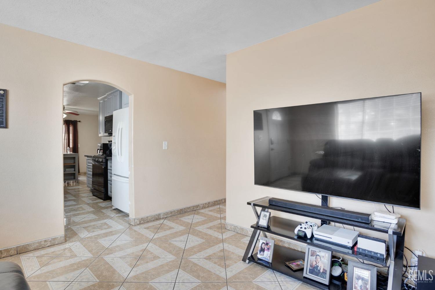 Undisclosed Address Bakersfield, CA 93307 - Photo 14 of 42 a living room with furniture and a flat screen tv