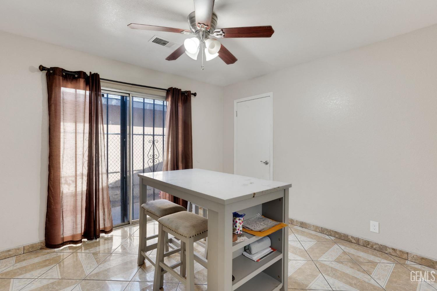 Undisclosed Address Bakersfield, CA 93307 - Photo 20 of 42 a view of a workspace with furniture and a window