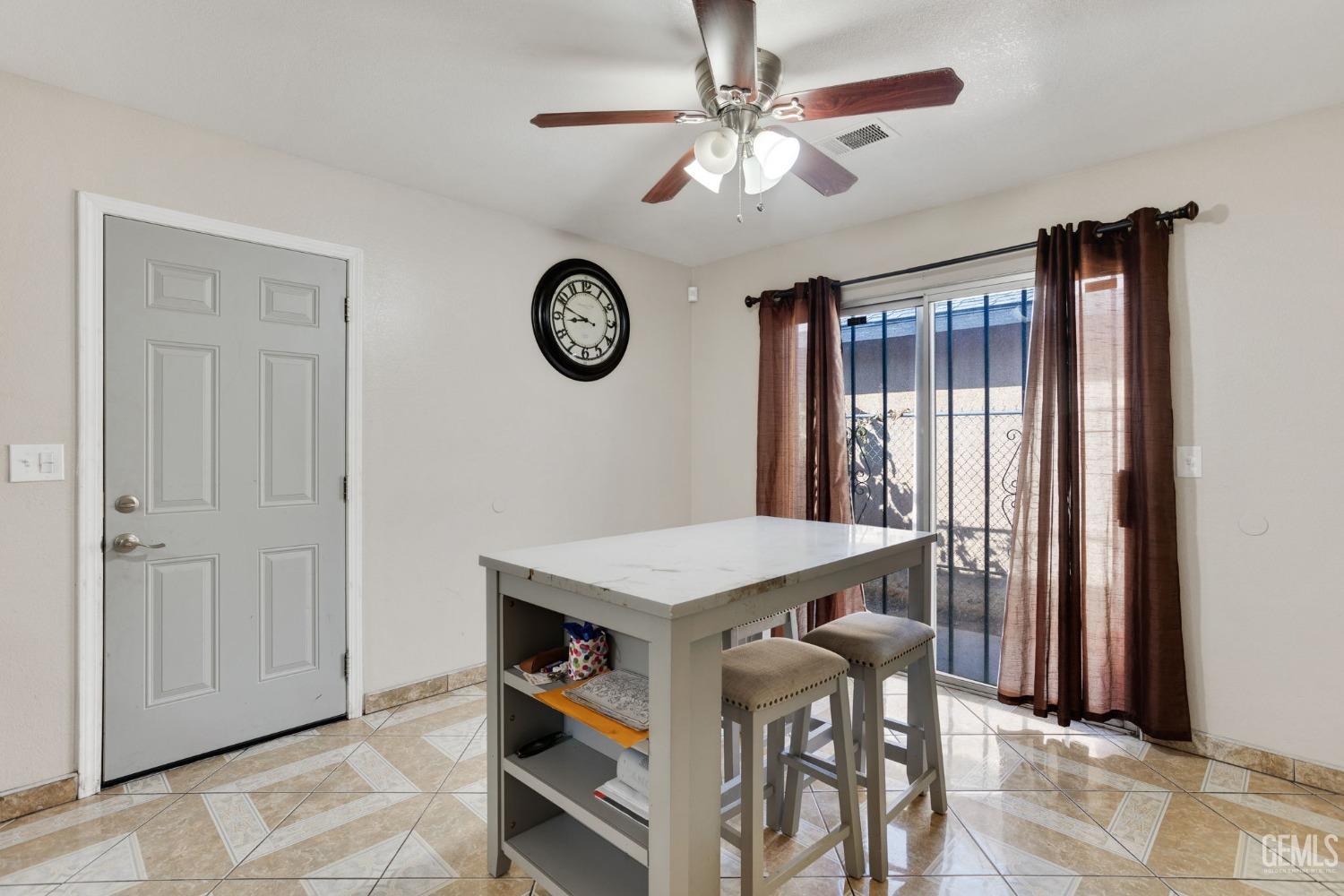 Undisclosed Address Bakersfield, CA 93307 - Photo 21 of 42 a view of a room with a table and a clock