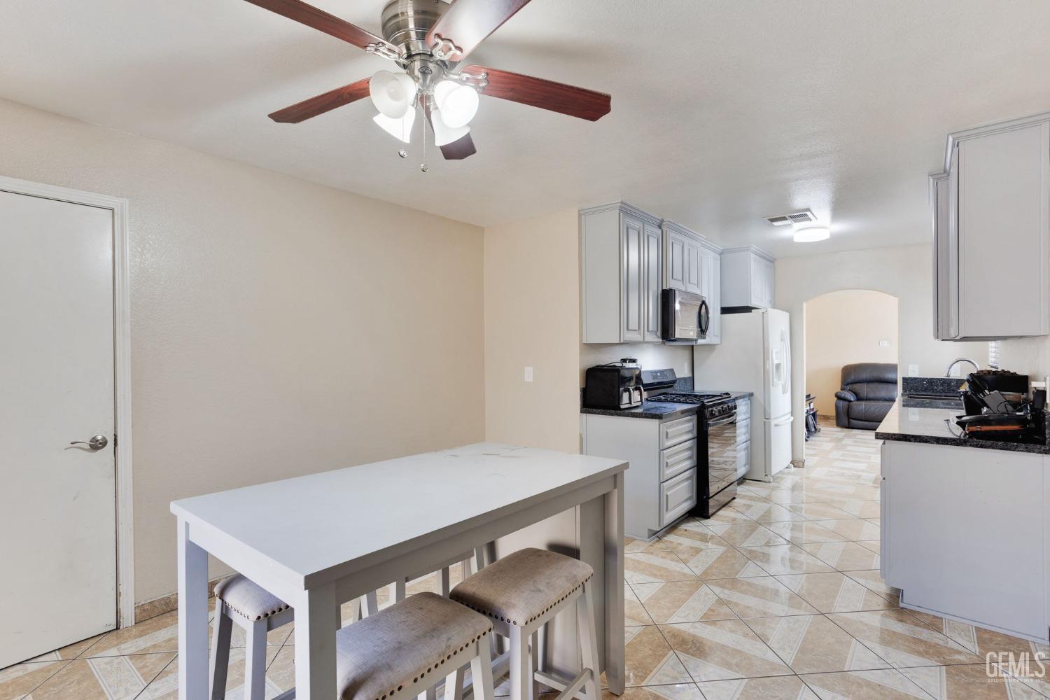 Undisclosed Address Bakersfield, CA 93307 - Photo 22 of 42 a kitchen with refrigerator cabinets and furniture