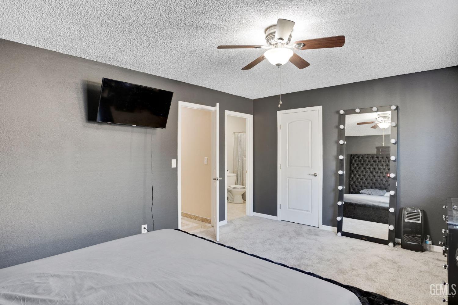Undisclosed Address Bakersfield, CA 93307 - Photo 26 of 42 a living room with furniture and a flat screen tv