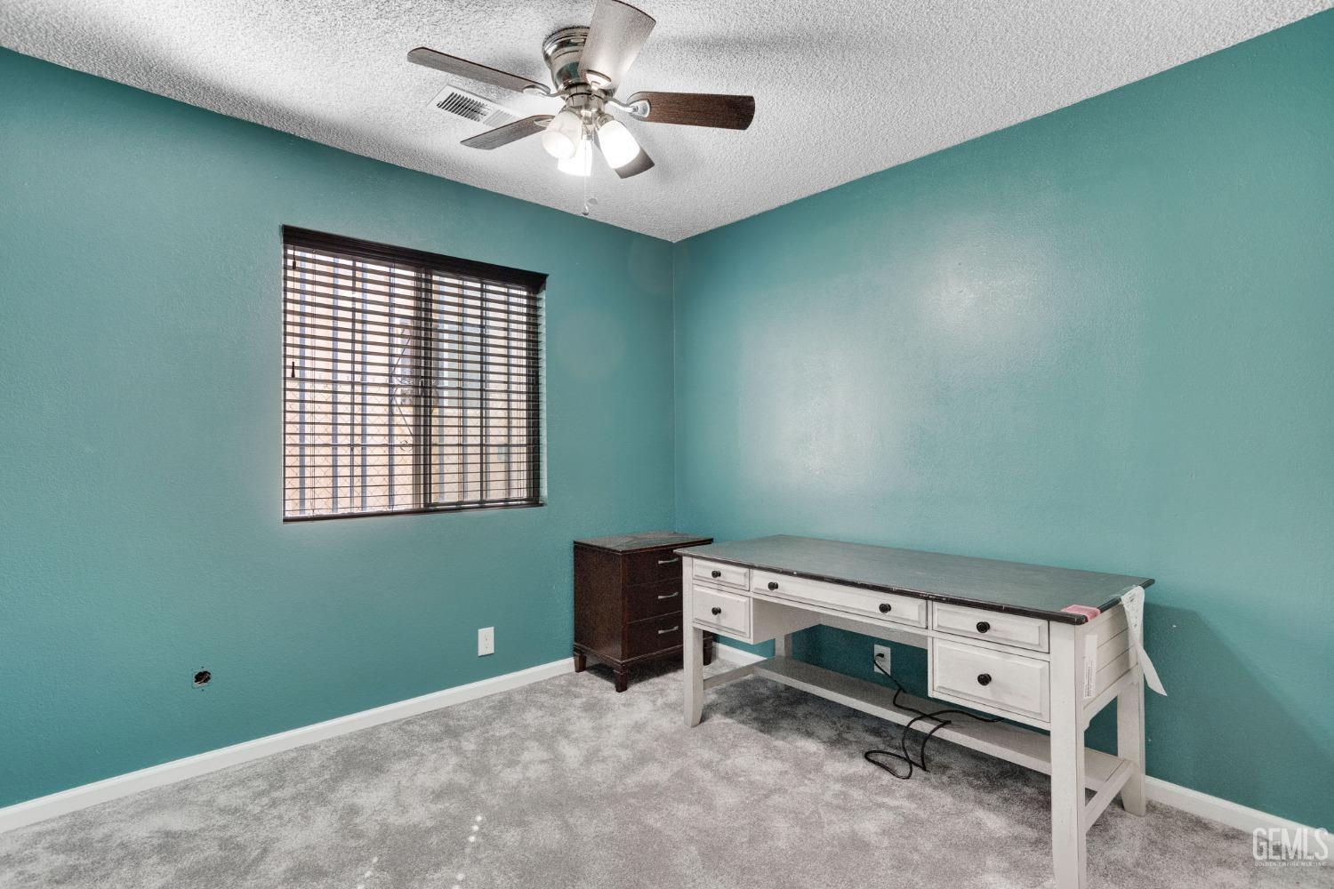 Undisclosed Address Bakersfield, CA 93307 - Photo 28 of 42 a view of a room with a ceiling fan and a window