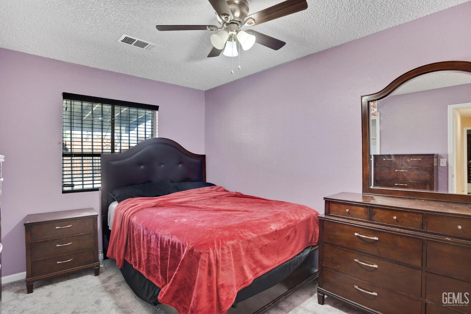 Undisclosed Address Bakersfield, CA 93307 - Photo 30 of 42 a bedroom with a bed and a dresser