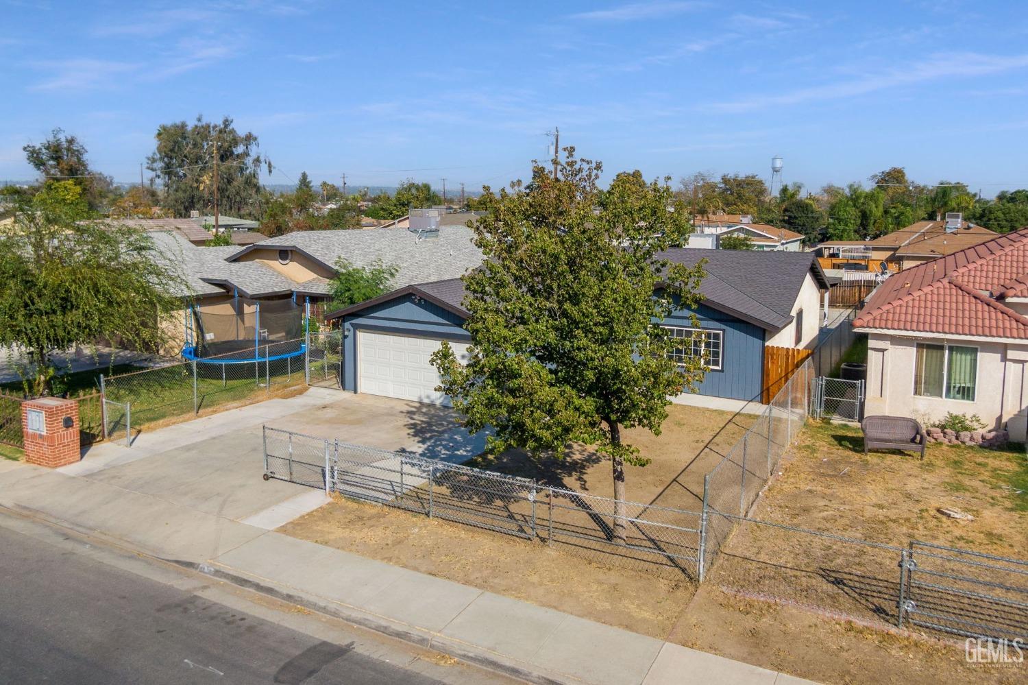 Undisclosed Address Bakersfield, CA 93307 - Photo 4 of 42 front view of a house with a yard