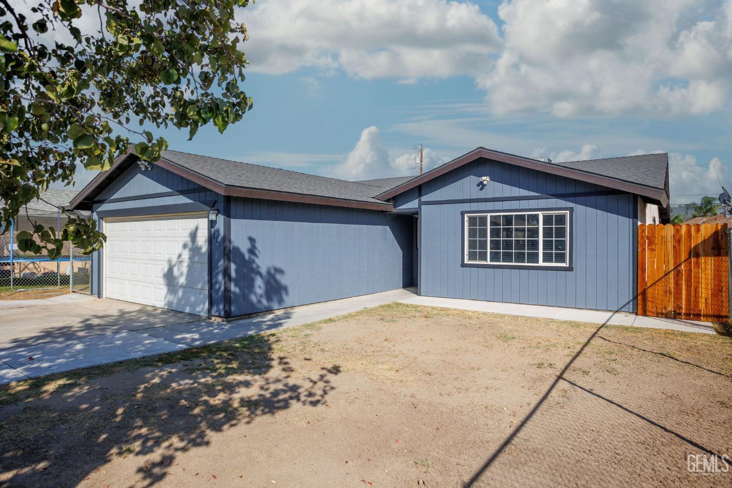 Undisclosed Address Bakersfield, CA 93307 - Photo 8 of 42 a front view of a house with a yard