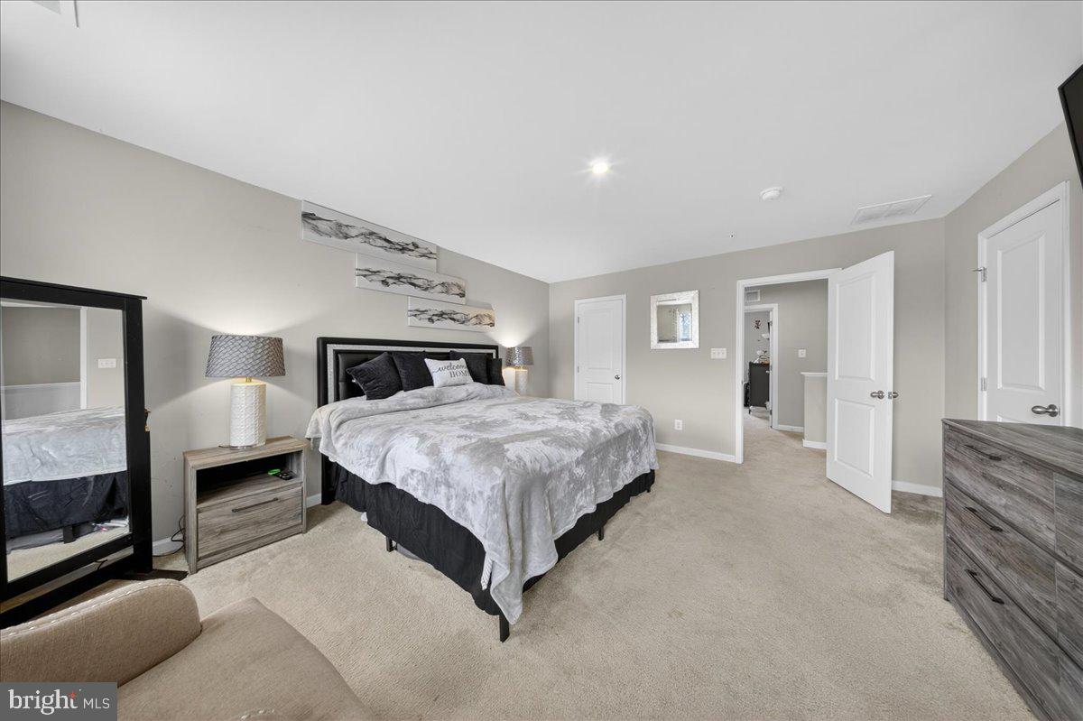 2 Ridgely Forest Drive Elkton, MD 21921 - Photo 16 of 35 a spacious bedroom with a bed a mirror and lamp