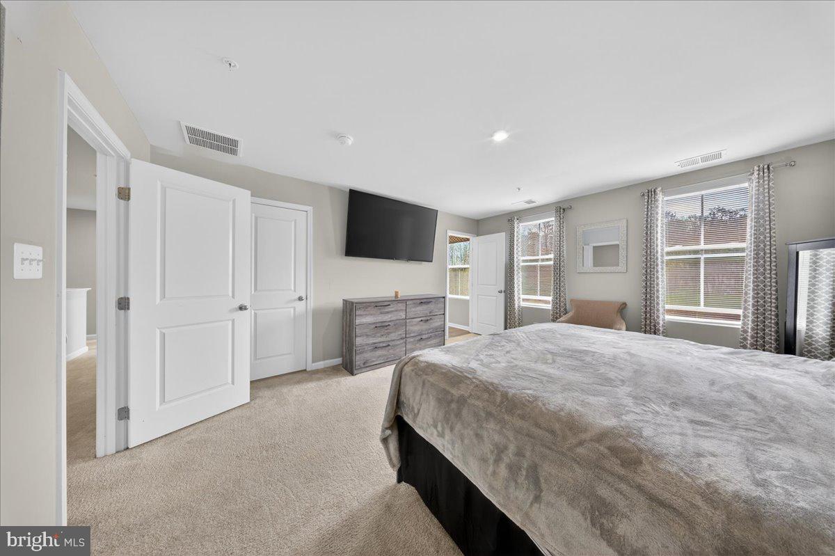 2 Ridgely Forest Drive Elkton, MD 21921 - Photo 17 of 35 a spacious bedroom with a large bed and a flat screen tv