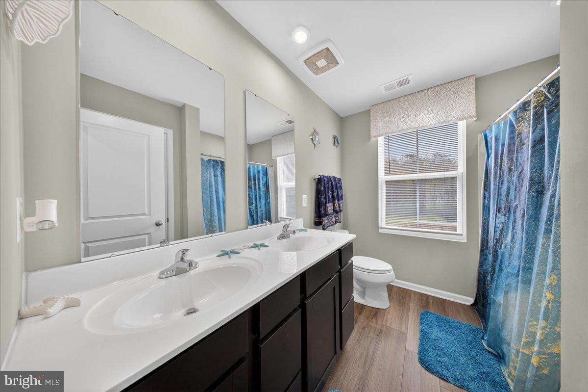 2 Ridgely Forest Drive Elkton, MD 21921 - Photo 23 of 35 a bathroom with a double vanity sink toilet and shower