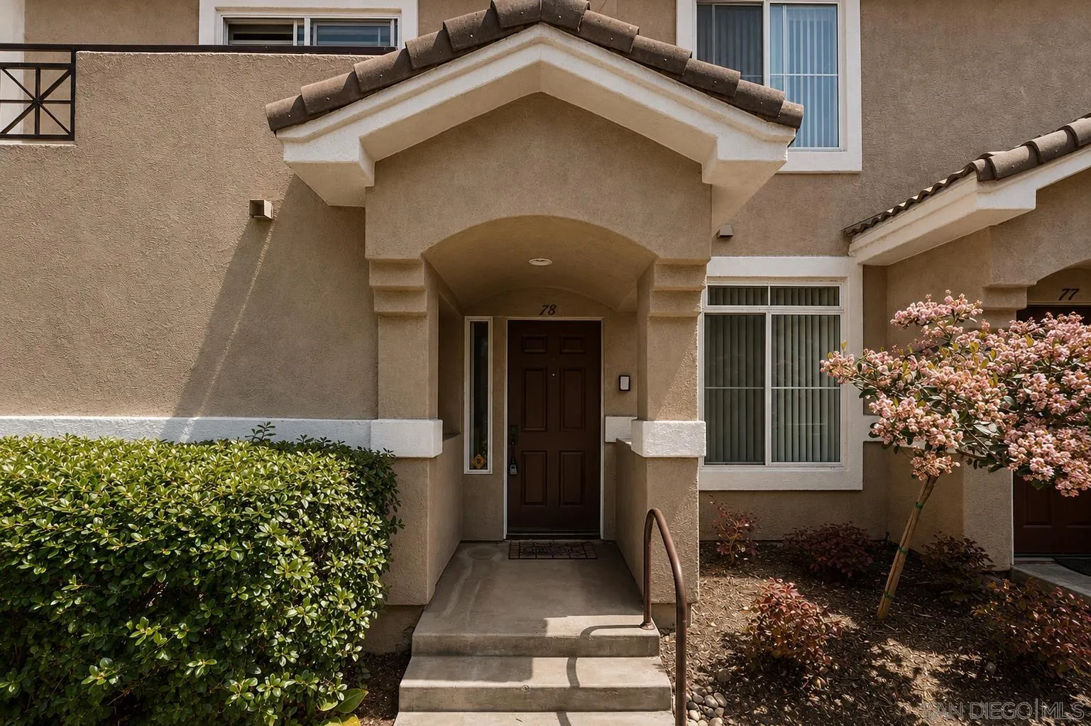 9338 Babauta Road, Unit 78 San Diego, CA 92129 - Photo 2 of 26 a front view of a house with garden