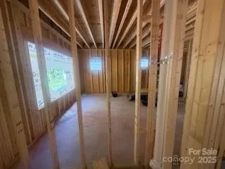 a view of a hallway with wooden floor and stairs