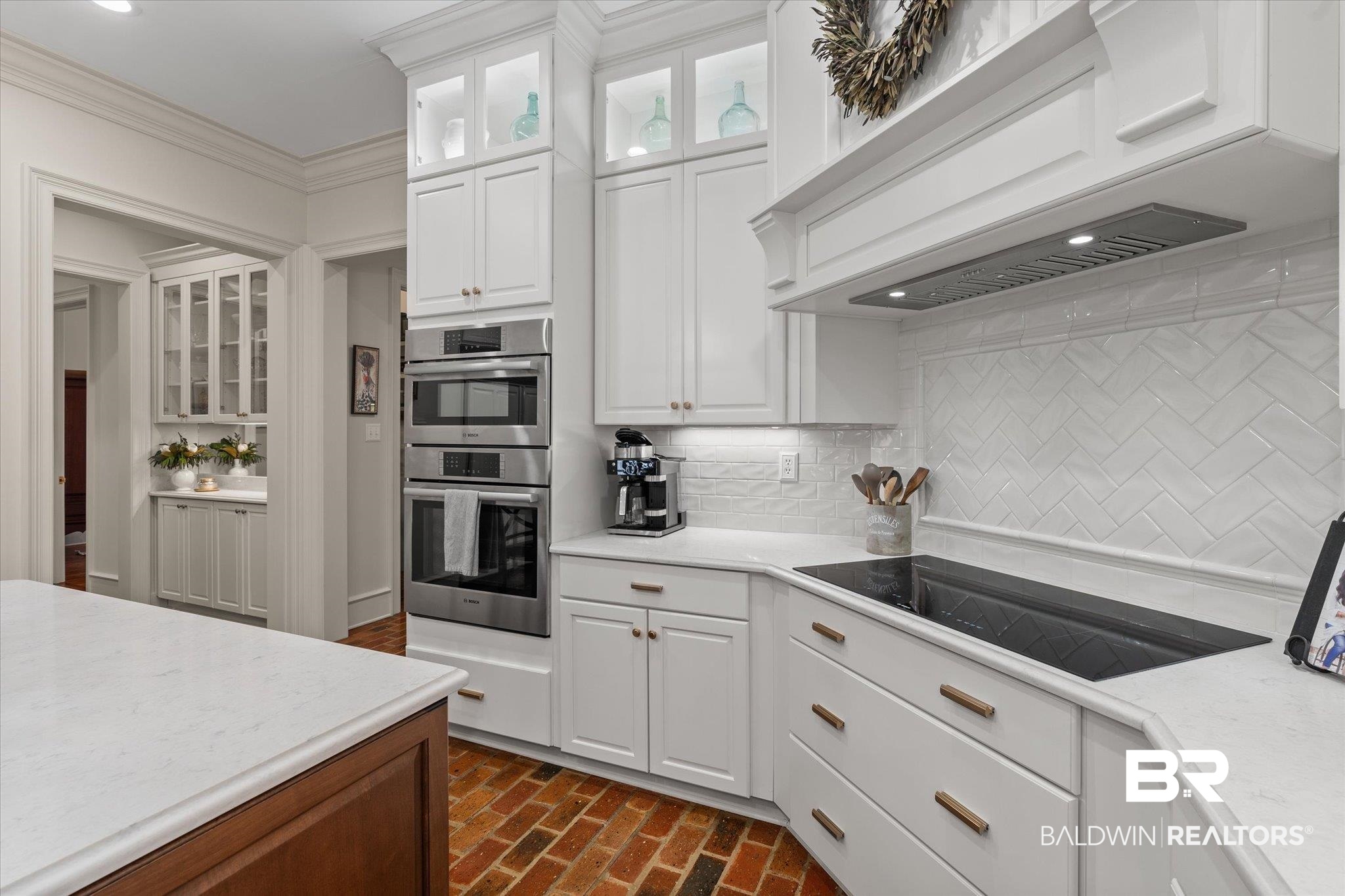 8561 Dawes Lake Road Mobile, AL 36619 - Photo 10 of 63 Kitchen with premium range hood, double oven, black electric stovetop, brick flooring, and backsplash