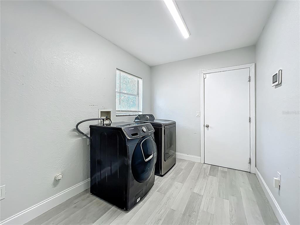 12368 Killian Street Spring Hill, FL 34609 - Photo 20 of 25 a view of storage and utility room in wooden floor