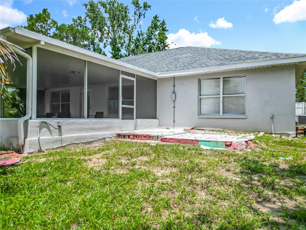 12368 Killian Street Spring Hill, FL 34609 - Photo 22 of 25 a front view of a house with a yard