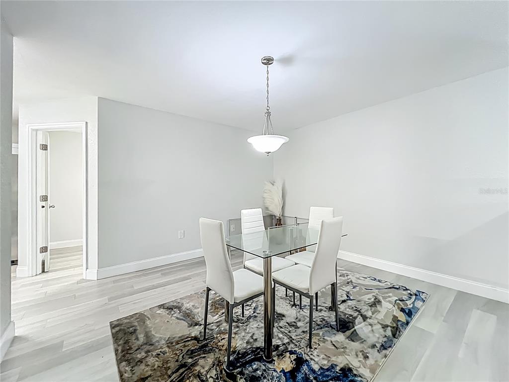 12368 Killian Street Spring Hill, FL 34609 - Photo 7 of 25 a view of a dining room with furniture
