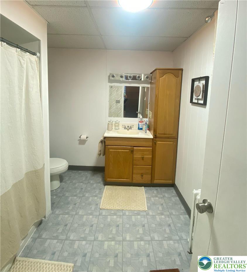 207 Chestnut Street Slatington, PA 18080 - Photo 15 of 26 a bathroom with a granite countertop sink mirror vanity and toilet