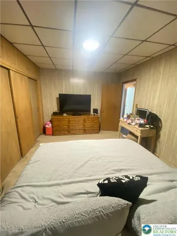 a bed room with a bed and a television