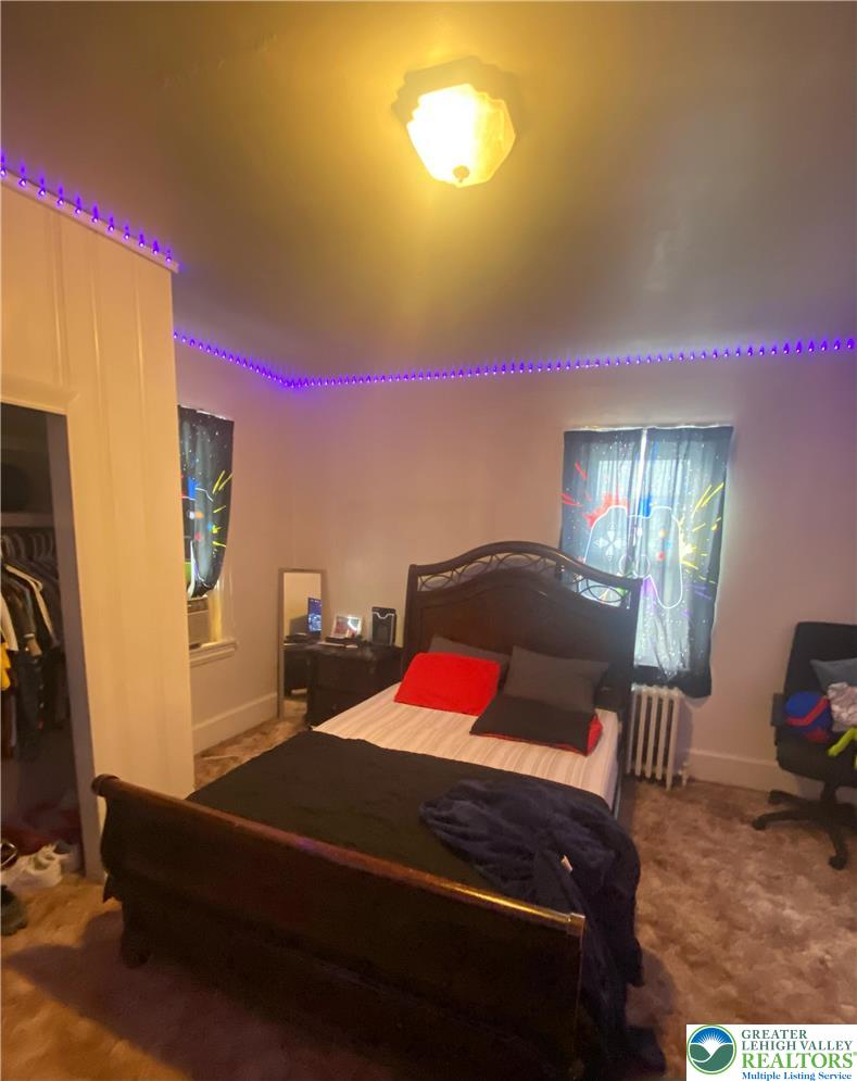 207 Chestnut Street Slatington, PA 18080 - Photo 21 of 26 a bedroom with a bed and wooden floor