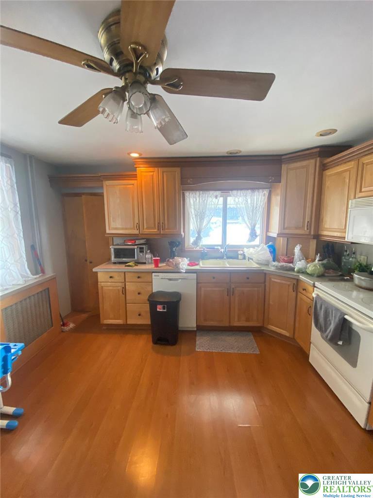 207 Chestnut Street Slatington, PA 18080 - Photo 9 of 26 a kitchen with granite countertop a sink cabinets stainless steel appliances and a large window