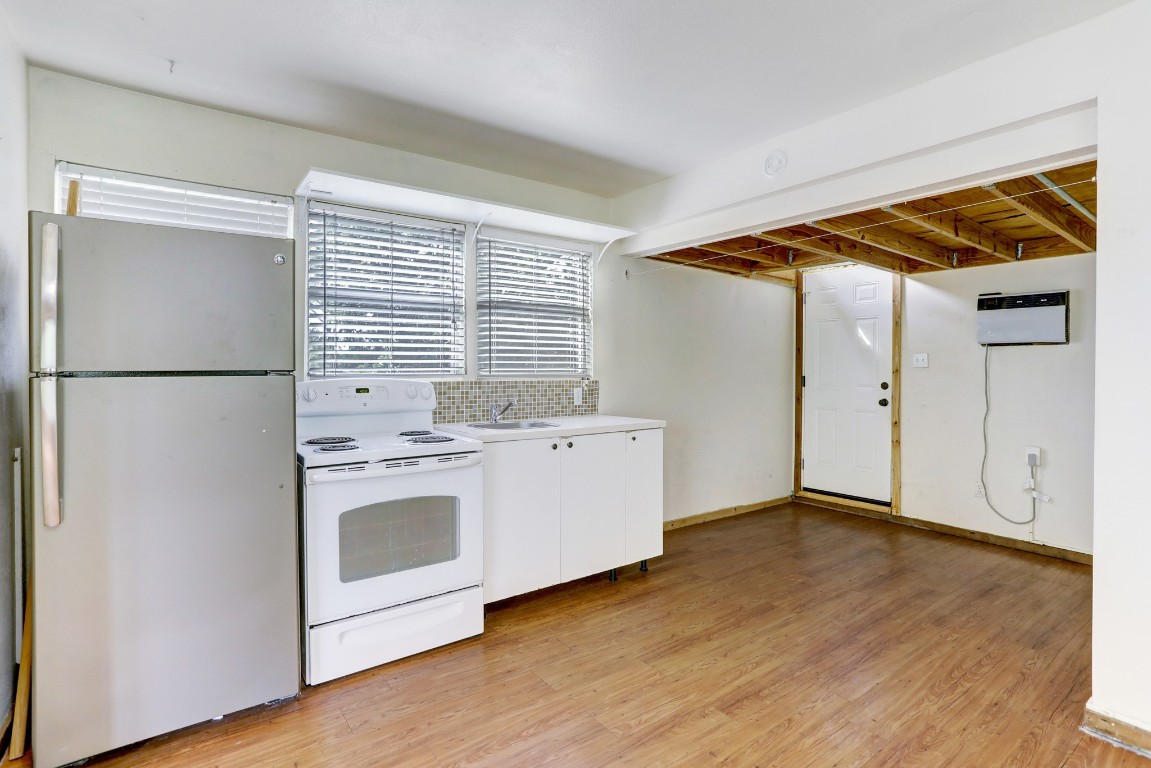 901 Newman Drive, Unit B Austin, TX 78703 - Photo 2 of 9 a kitchen with a refrigerator and a stove top oven