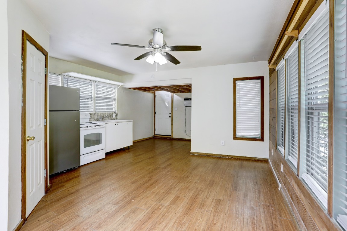 901 Newman Drive, Unit B Austin, TX 78703 - Photo 4 of 9 a view of a kitchen with a fridge wooden floor and a window