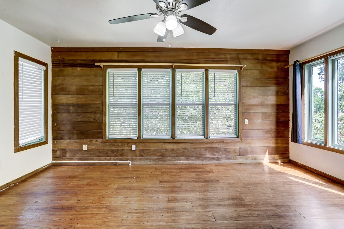 901 Newman Drive, Unit B Austin, TX 78703 - Photo 6 of 9 a view of an empty room with wooden floor and a window