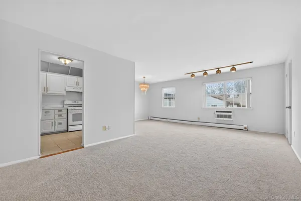an empty room with windows and closet