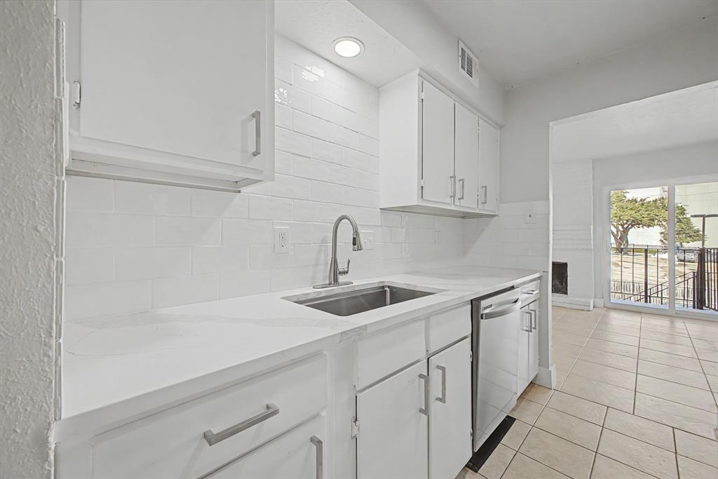 8095 Meadow Road, Unit 236 Dallas, TX 75231 - Photo 12 of 25 a kitchen with white cabinets a sink and dishwasher