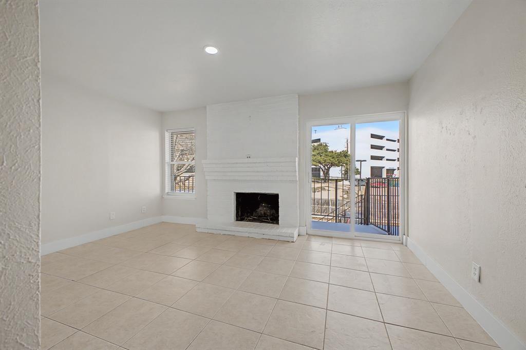 8095 Meadow Road, Unit 236 Dallas, TX 75231 - Photo 15 of 25 a view of a livingroom with a fireplace