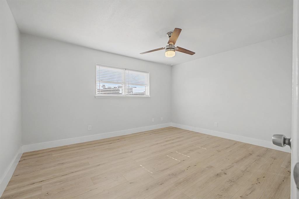 8095 Meadow Road, Unit 236 Dallas, TX 75231 - Photo 19 of 25 an empty room with a window and a ceiling fan