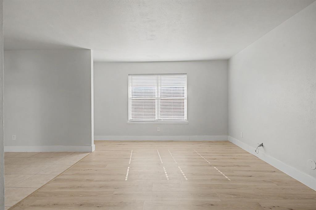 8095 Meadow Road, Unit 236 Dallas, TX 75231 - Photo 6 of 25 wooden floor in an empty room with a window