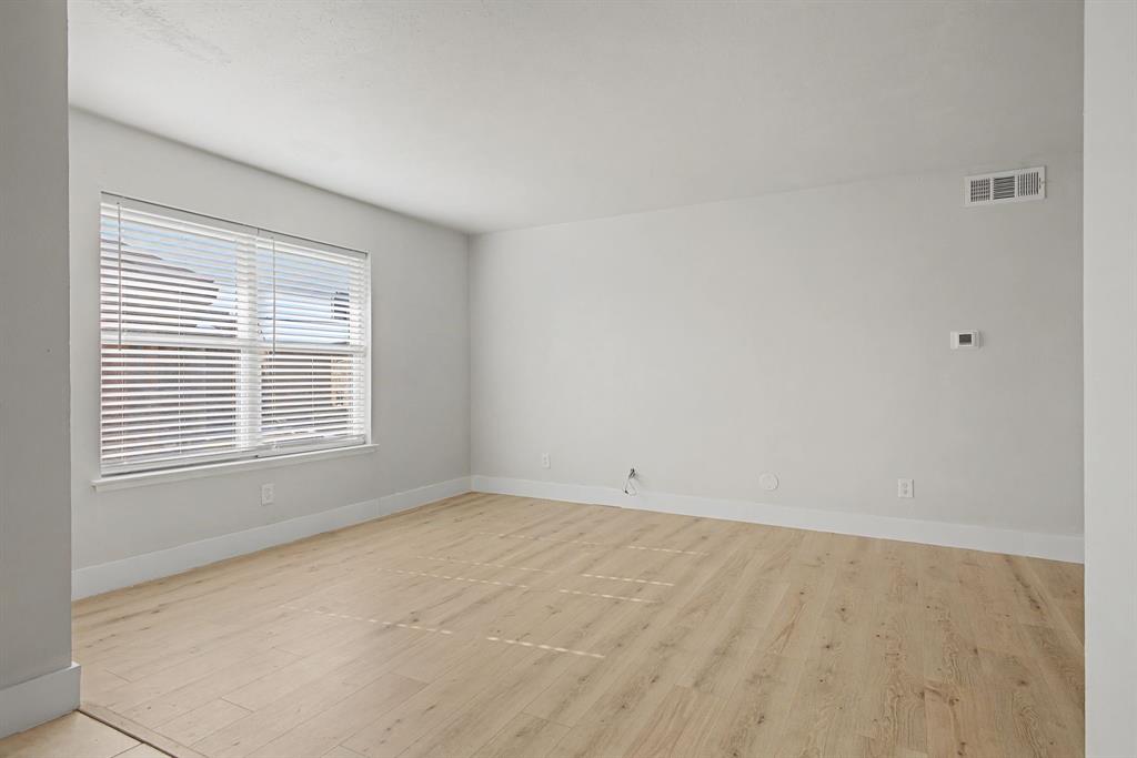 8095 Meadow Road, Unit 236 Dallas, TX 75231 - Photo 8 of 25 a view of an empty room with a window