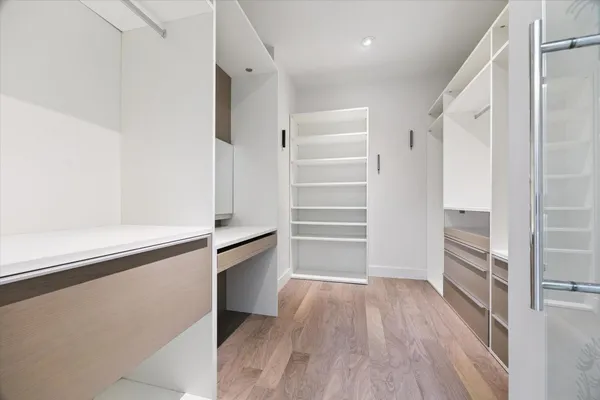 a view of walk in closet with empty racks