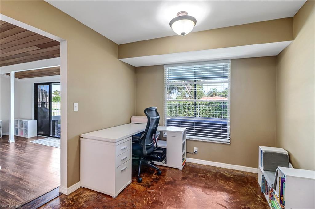 103 Doral Circle Naples, FL 34113 - Photo 12 of 25 a view of a workspace with furniture and a window