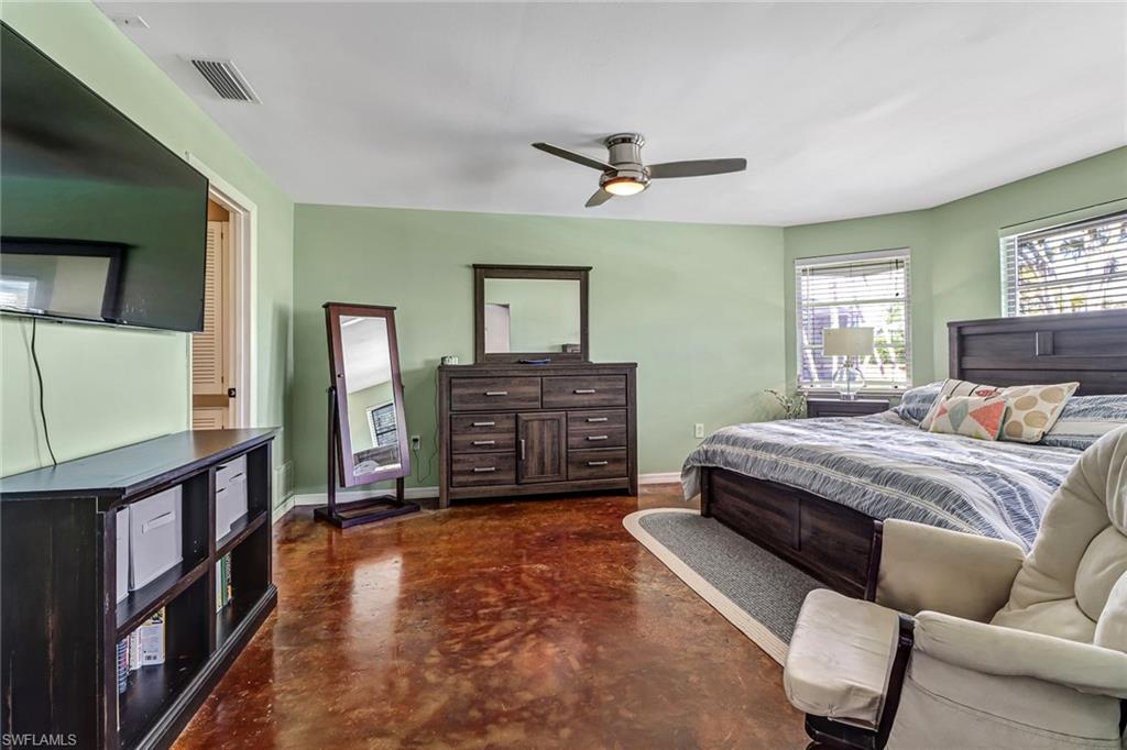 103 Doral Circle Naples, FL 34113 - Photo 13 of 25 a bedroom with a bed dresser and a window