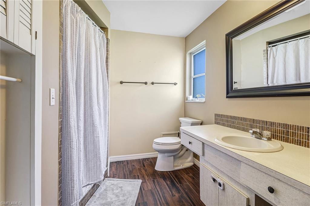 103 Doral Circle Naples, FL 34113 - Photo 15 of 25 a bathroom with a sink toilet and shower