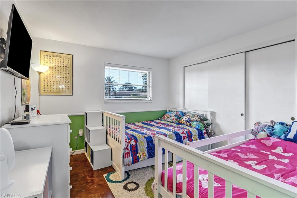 103 Doral Circle Naples, FL 34113 - Photo 16 of 25 a bedroom with furniture and a flat screen tv