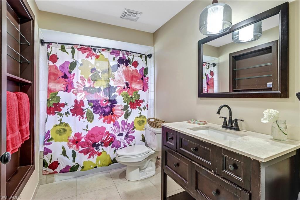103 Doral Circle Naples, FL 34113 - Photo 17 of 25 a bathroom with a sink mirror and vanity