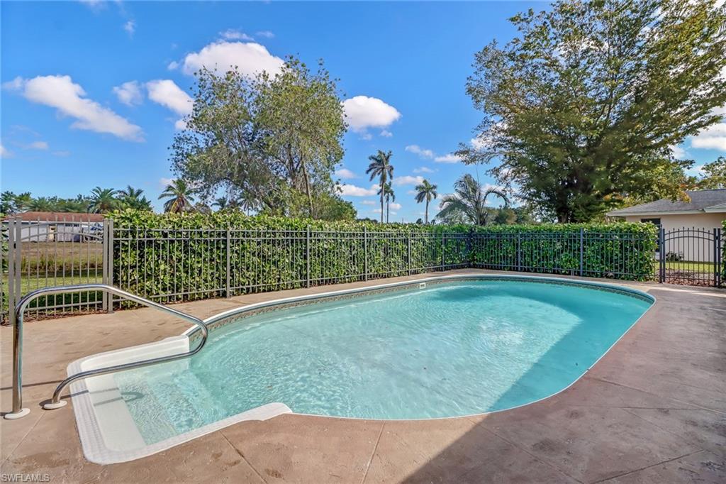 103 Doral Circle Naples, FL 34113 - Photo 19 of 25 a view of a swimming pool with a patio