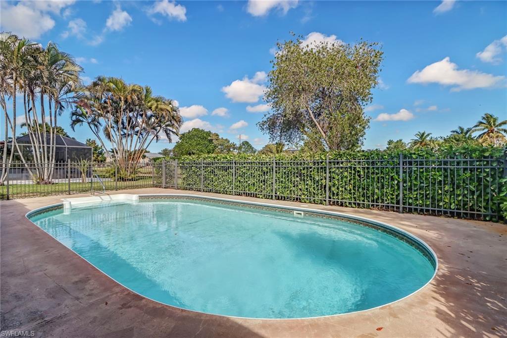 103 Doral Circle Naples, FL 34113 - Photo 20 of 25 a view of a swimming pool with a yard