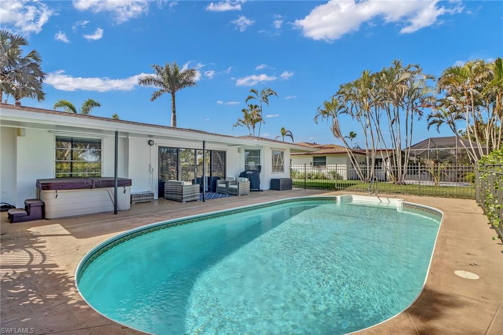 103 Doral Circle Naples, FL 34113 - Photo 21 of 25 a view of a house with swimming pool and sitting area