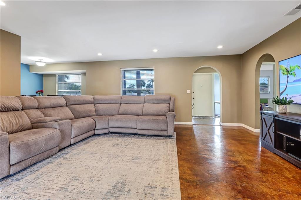 103 Doral Circle Naples, FL 34113 - Photo 4 of 25 a living room with furniture and a flat screen tv