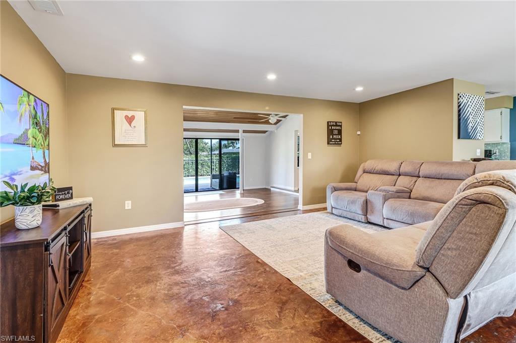 103 Doral Circle Naples, FL 34113 - Photo 5 of 25 a living room with furniture and a flat screen tv