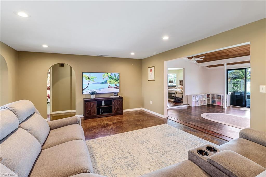 103 Doral Circle Naples, FL 34113 - Photo 6 of 25 a living room with furniture and a fireplace