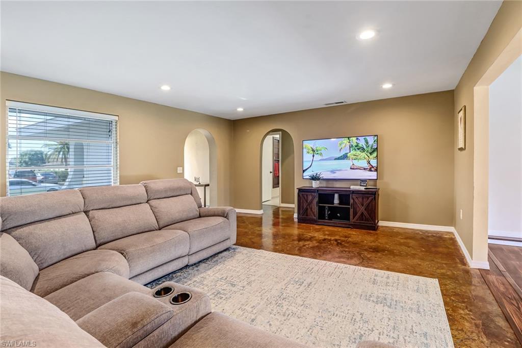 103 Doral Circle Naples, FL 34113 - Photo 7 of 25 a living room with furniture and a fireplace