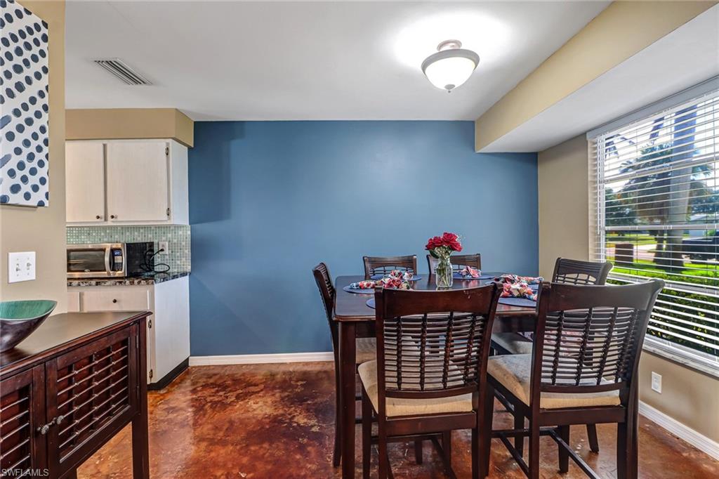 103 Doral Circle Naples, FL 34113 - Photo 9 of 25 a dining room with furniture and window
