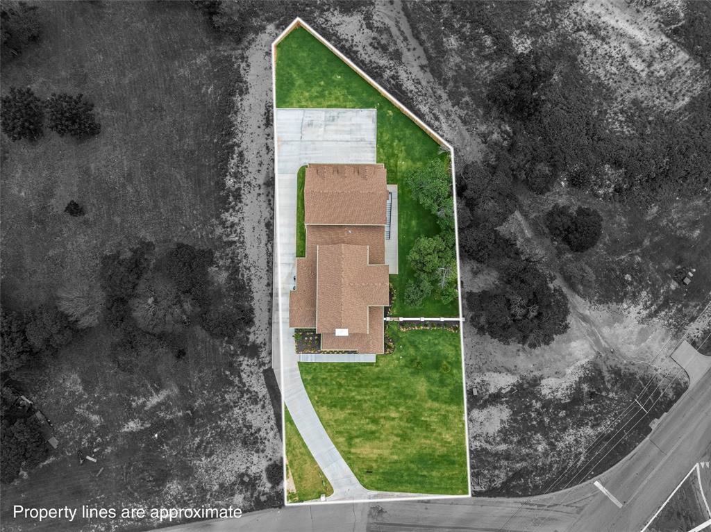 20 Ritchie Road Woodway, TX 76712 - Photo 39 of 40 Expansive lot with a large residential structure, featuring a substantial green lawn, concrete driveway, and mature trees