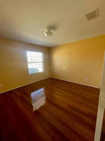 a view of wooden floor and windows in a room