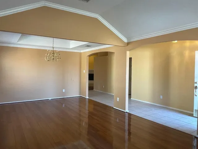 an empty room with wooden floor and closet