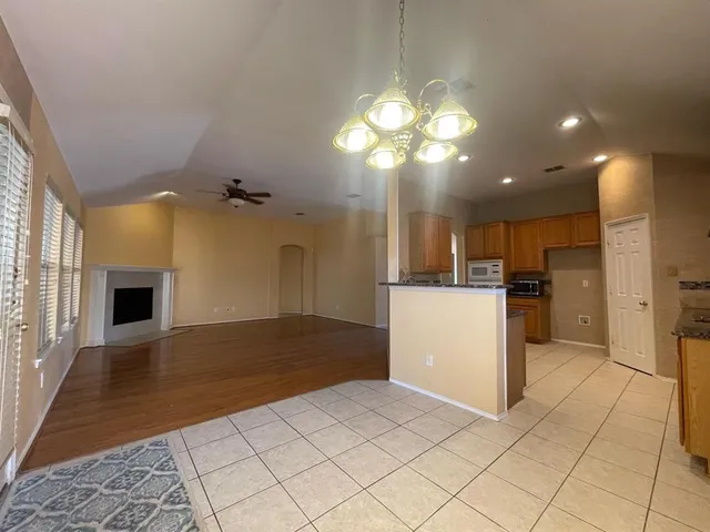 a view of a kitchen with a sink and a refrigerator
